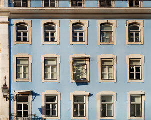 Fototapeta premium Typical old buildings in Lisbon's lower town, with their windows with balconies, lanterns, and decorative tiles. Lisbon, Portugal, 2023