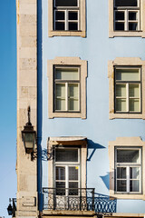 Fototapeta premium Typical old buildings in Lisbon's lower town, with their windows with balconies, lanterns, and decorative tiles. Lisbon, Portugal, 2023