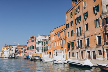 Venice canal with colorful buildings spanning along water