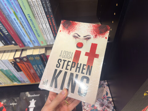BELO HORIZONTE, MG, BRAZIL &ndash; NOVEMBER, 26, 2025: A hand holds a copy of Stephen King's novel "A Coisa (It)" in a bookstore.