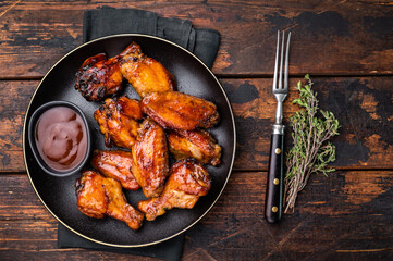 Deliciously sticky teriyakis sauce chicken wings, bursting with flavor, perfect for sharing at festive occasions or family dinners. wooden background. top view