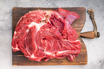 Fresh raw beef neck meat, perfect for slow cooking and creating rich, flavorful stews and hearty dishes. white background. top view