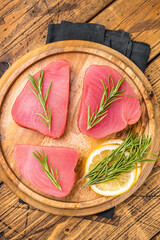 High quality raw tuna steak loin, perfect for a refreshing poke bowl or a delicious seared dish that impresses every time. wooden background. top view