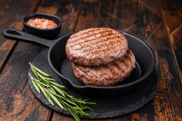 Deliciously charred grilled meat burger patty on the grill, perfect for satisfying cravings at any cookout. wooden background. top view