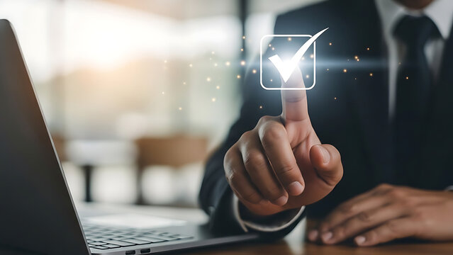Businessman s finger touching a digital checkmark on a screen