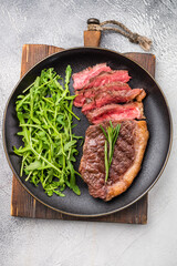 Tender grilled striploin New York steak paired with fresh vegetables, the ultimate comfort food for any occasion. white background. top view