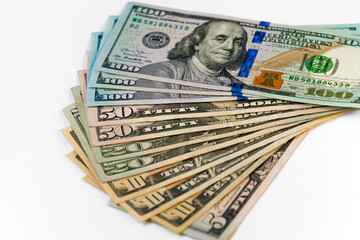 New dollar banknote USA of different denominations folded like a fan in blur.  White background, isolated.