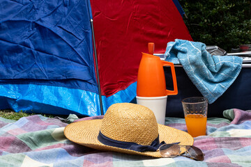 Enjoying summer leisure in the countryside. A colorful tent pitched as a comfortable base for...