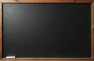 Empty black chalkboard in wooden frame with piece of white chalk. Dark blackboard surface. Clean school board for announcements information. Retro stylish background for design. Copy space available.