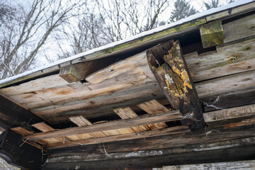 Damaged and decayed part of beams at an old wooden cottage.
