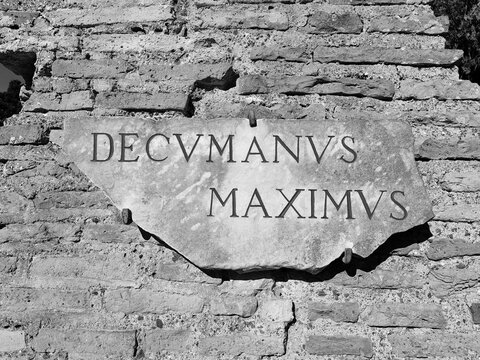 Ostia Antica, Italy - November 23, 2025, the plaque of the decumanus maximus, the main street with an east-west orientation in Roman urban planning, in the archaeological excavations of Ostia Antica.