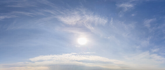 Obraz premium Bright Blue Sky With Wispy Clouds Over Calm Horizon – Cloudscape Background