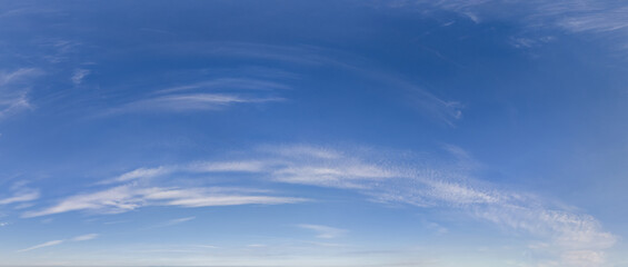 Fototapeta premium Bright Blue Sky With Wispy Clouds Over Calm Horizon – Cloudscape Background