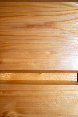 Wooden background with a varnished wood panel texture. Natural wooden surface ideal for design, interior backgrounds, and rustic-themed projects