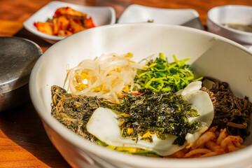 Korean Bibimbap Bowl with Fresh Vegetables and Seaweed