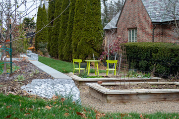 Backyard garden landscape with raised beds and lime green seating area
