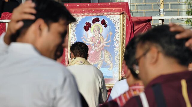 Indian devotees celebrating Durga Puja festival, offering prayers to goddess Durga
