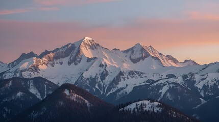 A breathtaking view of towering, snow-covered mountain peaks under a soft pastel sky.