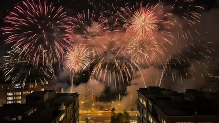 Aerial view of multiple fireworks eksplosion 4K display above the cityscape in the night. celebrate, newyear, holiday, background