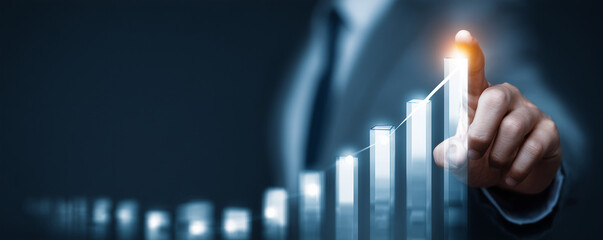 Business professional points at a digital growth chart representing increased success and profitability
