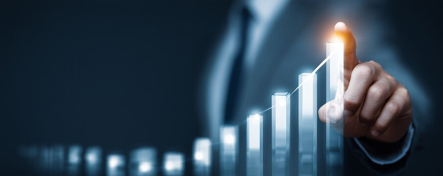 Business professional points at a digital growth chart representing increased success and profitability