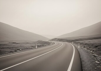Serpentine Road Through Mountainous Terrain Under an Overcast Sky