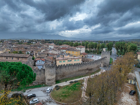 Aerial view of the historic city center of Rieti, city walls, towers, the Velino River, and Mount Terminillo's majestic backdrop