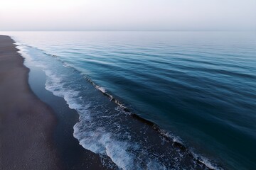 Gentle shoreline with soft waves meeting empty horizon creating peaceful minimalist seascape evoking calm serenity