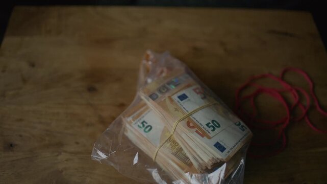 Corrupt businessman counting euro banknotes and hiding cash in envelopes 
