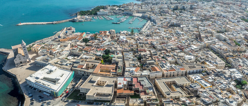 Aerial View of Trani: The Medieval Swabian Castle, Historic Old Town, and Vibrant Fishing Port along the Adriatic Coastline
