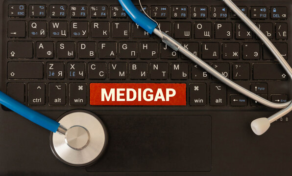 MEDIGAP text on a keyboard with stethoscope , medical concept