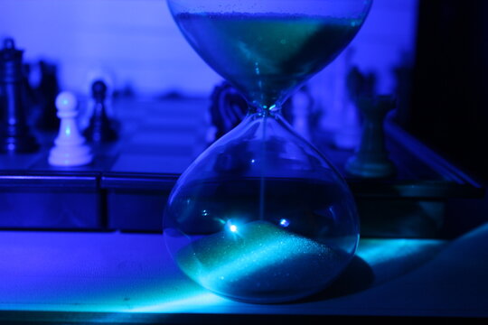 Hourglass and chess onthe chess board timer and game  - Powered by Adobe