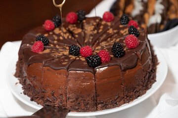 Chocolate cake with raspberries and blackberries on the icing