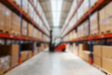 Defocused Background of Spacious and Organized Warehouse Interior with Forklifts and Shelves Stocked with Cardboard Boxes. Blurred Background Photo.