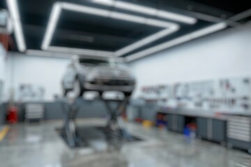 blurry image of the interior of a modern car repair shop, there is a car being repaired, without any people, blurry wallpaper.