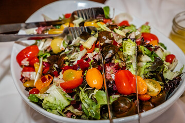 healthy salad plate with serving tongs