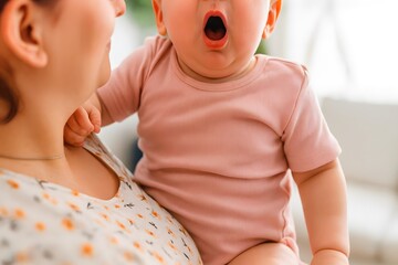 Close-up of a mother holding a yawning baby in warm natural light. Perfect for parenting themes, childcare, motherhood, infant care, bonding, and family lifestyle visuals.
