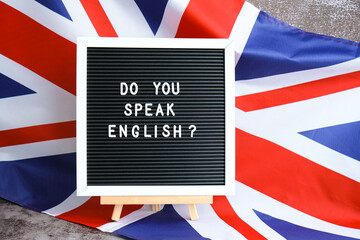 Message DO YOU SPEAK ENGLISH on background of Great Britain UK flag. British national flag with concept of High school university college education, language courses, online distance learning