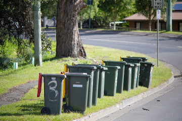 Hobart, Tasmania, Australia, November 19, 2025:  Outdoor view of a row of rubbish and recycling bins standing near the edge of the street after being emptied