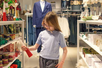 A girl in a store among Christmas decorations. Preparing for the New Year and Christmas. Buying decorations and gifts.