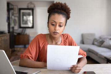 Serious young African American manager woman working from home