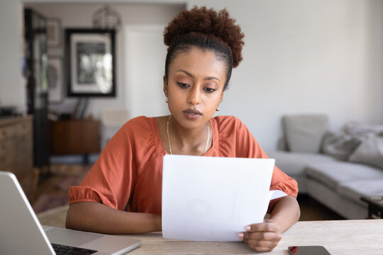 Serious young African American manager woman working from home - Powered by Adobe