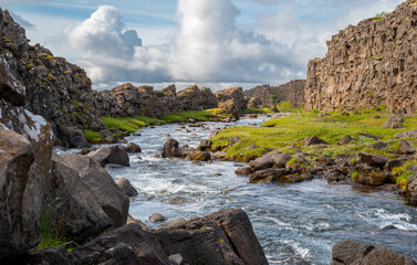 Iceland travel - Oxararfoss waterfall flows into the river where the North American and Eurasian tectonic plates meet.
