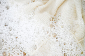 Cashmere Wool Sweater Being Hand Washed with Delicate Detergent