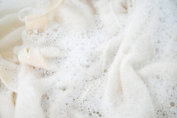 Cashmere Wool Sweater Being Hand Washed with Delicate Detergent