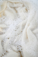 Cashmere Wool Sweater Being Hand Washed with Delicate Detergent