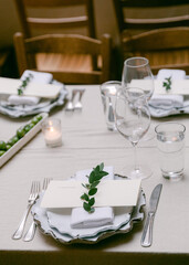 Elegant dinner setting with fresh greenery and simple tableware at a cozy restaurant