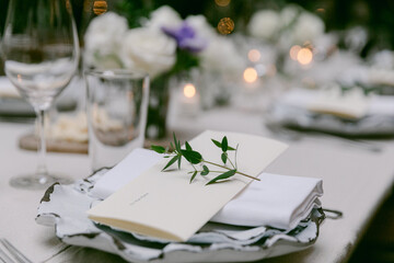 Elegant table setting with fresh flowers and candles for a special occasion in the evening light