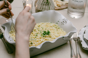 Fresh pasta served in an elegant dish at an intimate dining setting in the evening