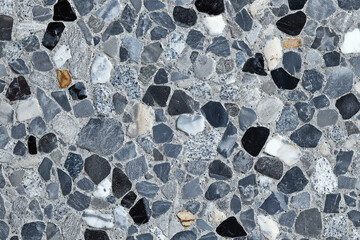 A textured surface with irregularly shaped stones embedded in concrete